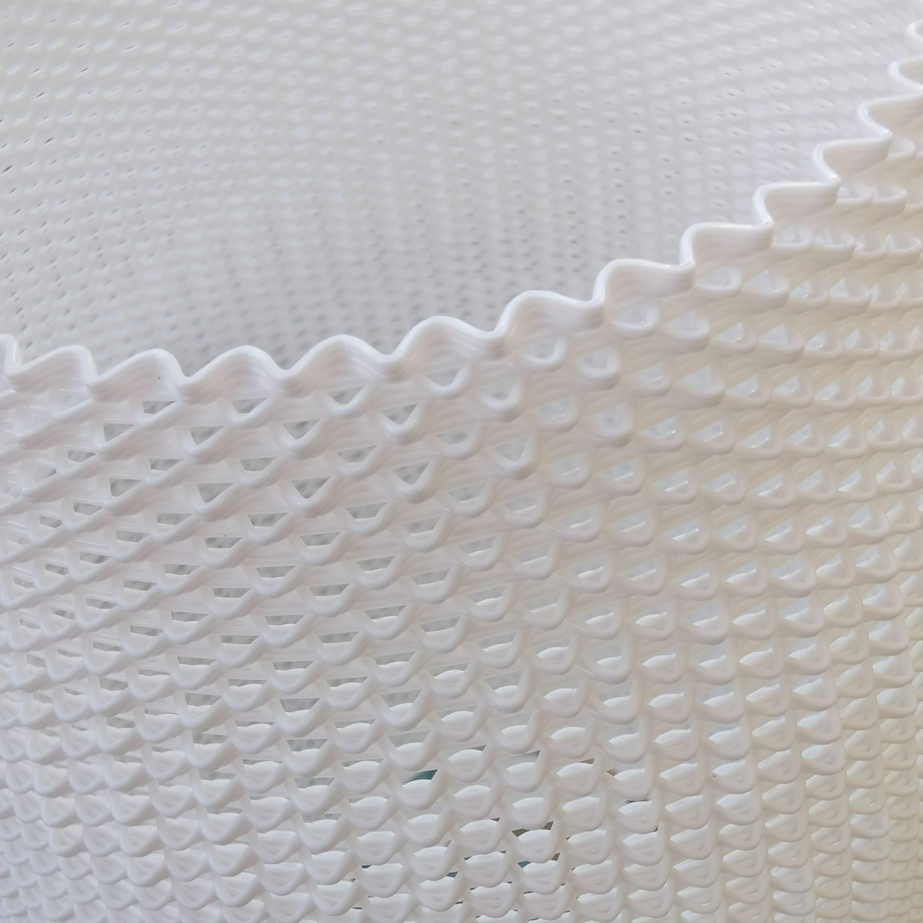 Close-up of a textured white surface with a wavy pattern