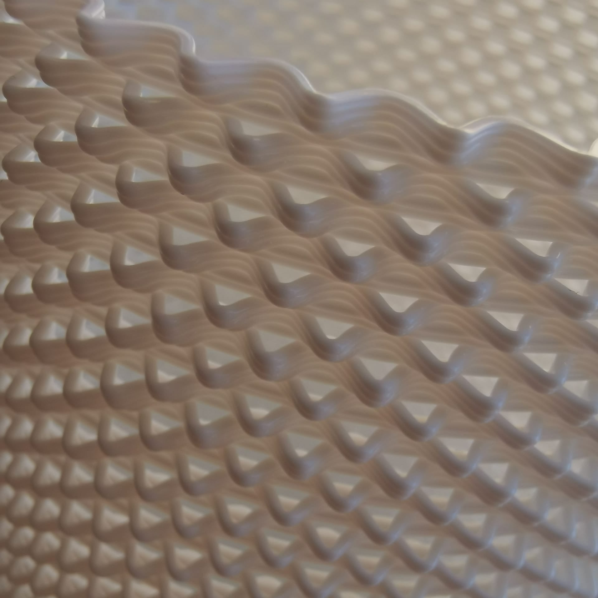 Close-up of a textured beige surface with wavy pattern