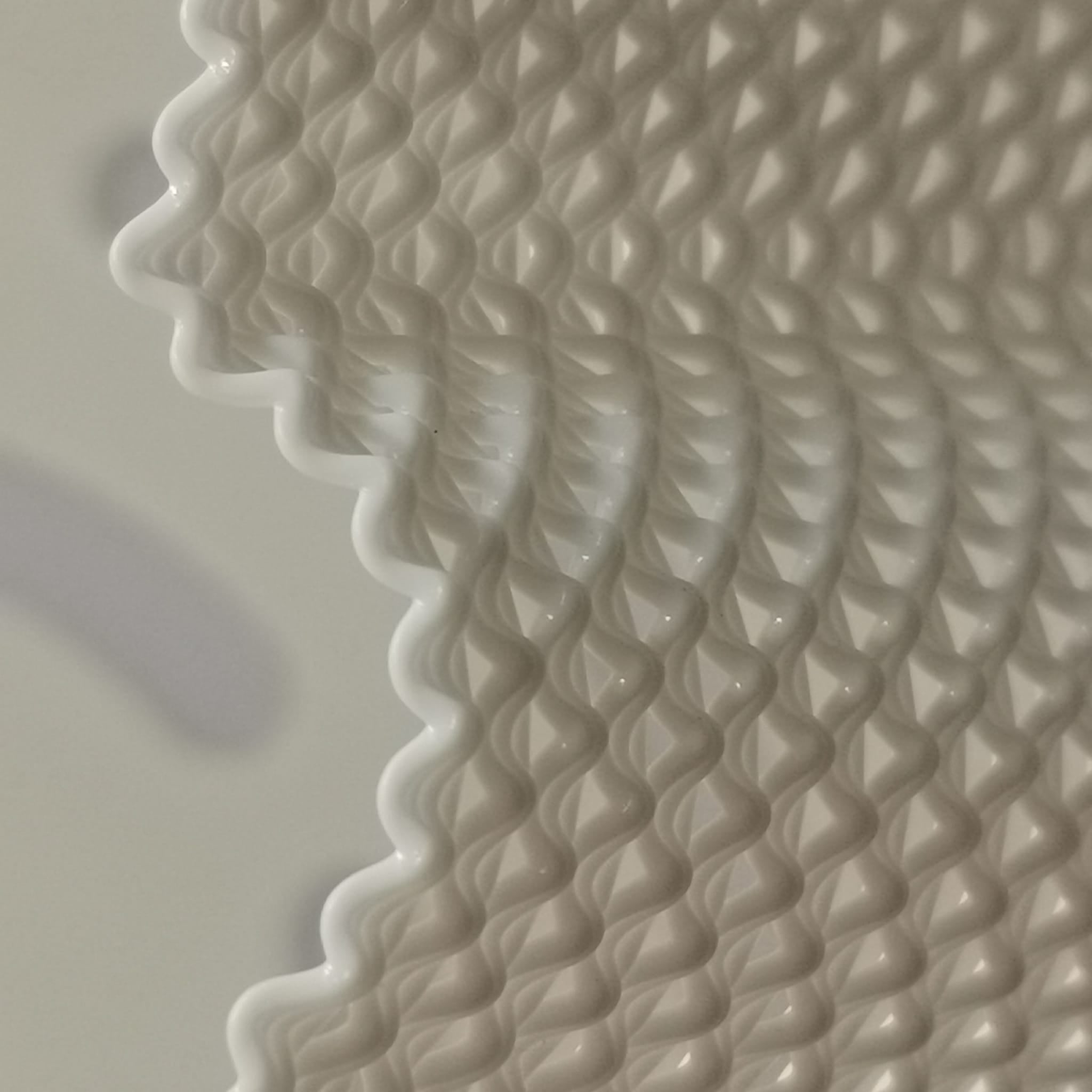 Close-up of textured white ceramic tile corner