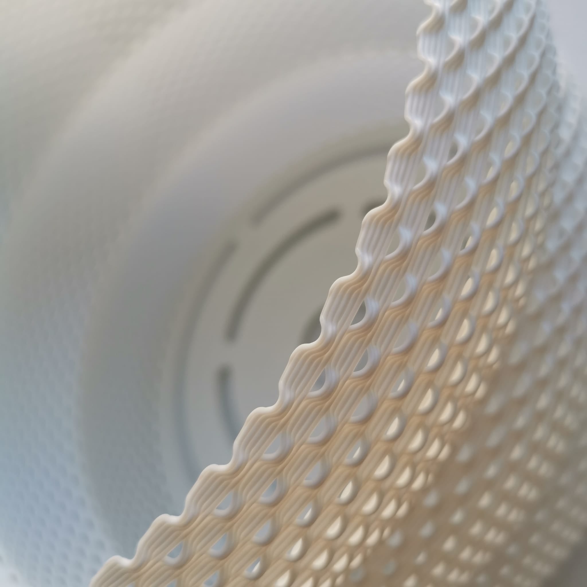 Close-up of a textured white object with circular patterns