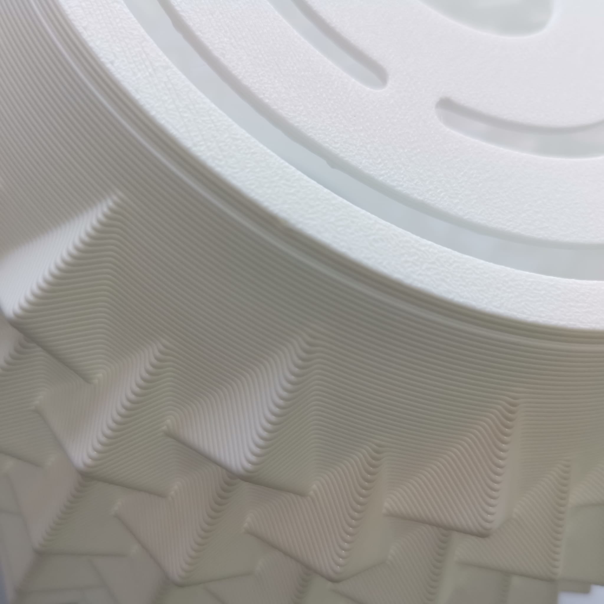 Close-up of a textured white plastic pendant lamp with circular design