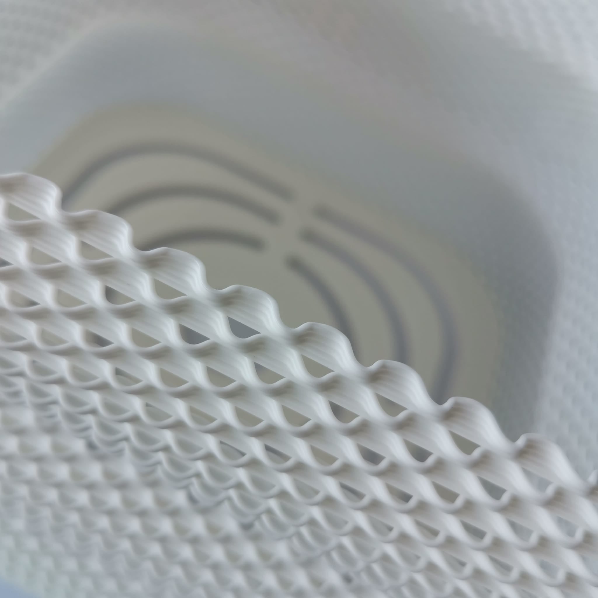 Close-up of a white textured material with a circular pattern in the background