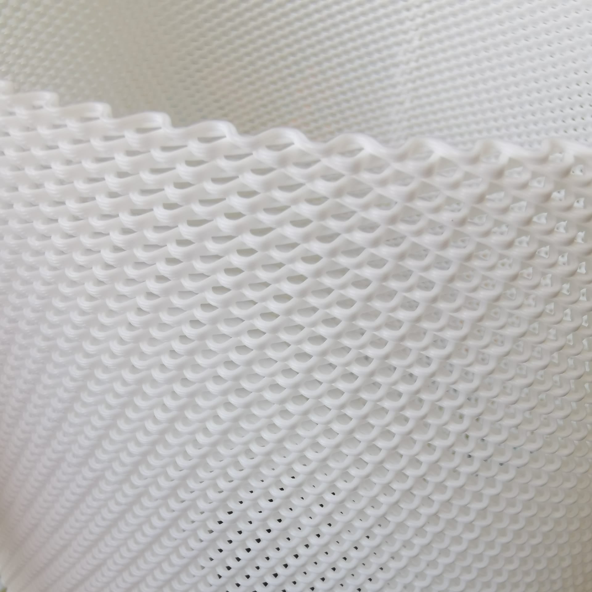 Close-up of a table lamp textured white fabric with a grid pattern