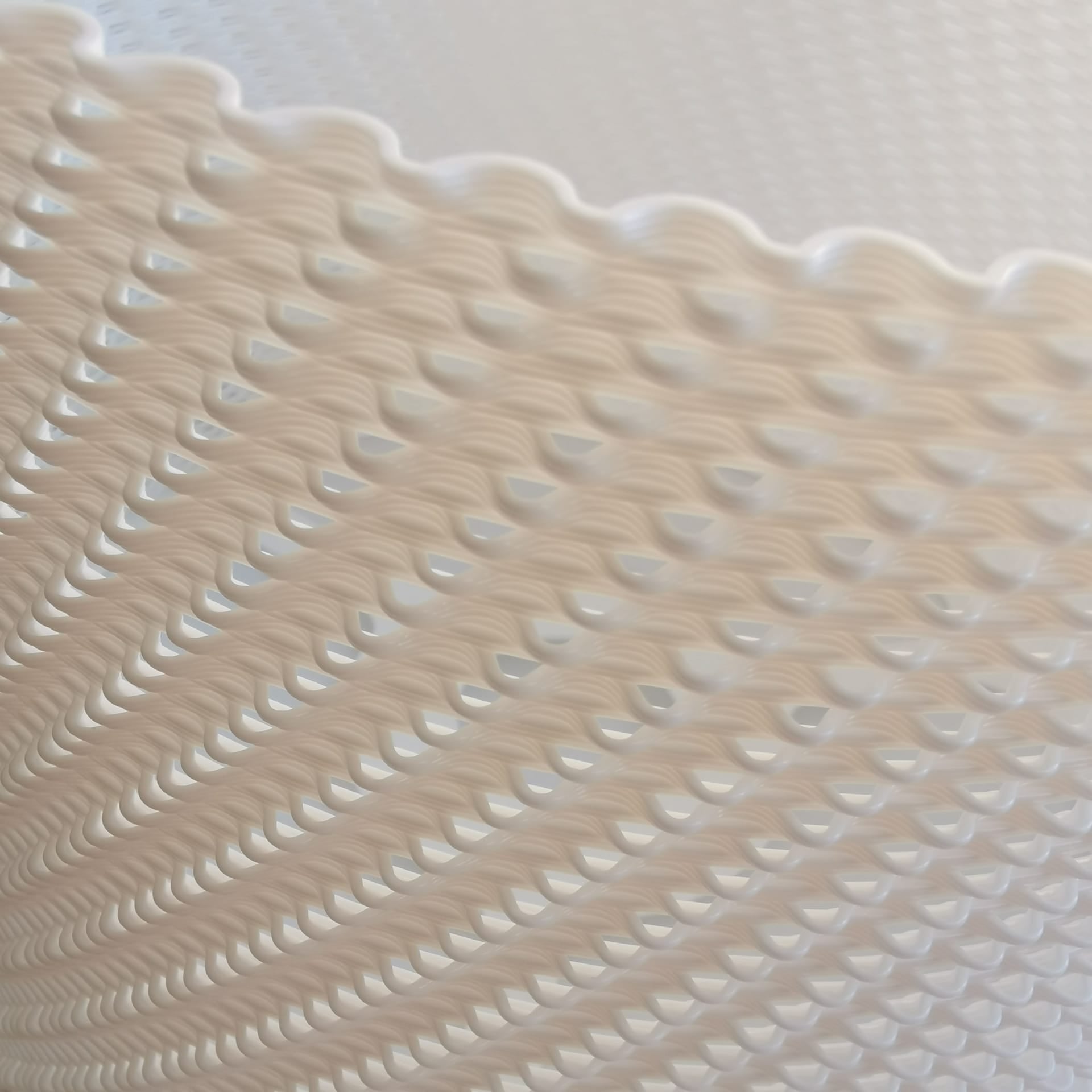 Textured beige surface with wavy pattern on a light gray background